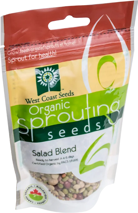 Sachet West Coast Seeds à partie supérieure rouge, avec une étiquette vert jaune portant le nom anglais Salad Blend. La fenêtre transparente laisse voir des graines vertes, rouges et beige, avec des graines plus fines. Le bas blanc de l'emballage présente le logo biologique canadien et les indications de germination. Le délai de 4 à 5 jours est visible sur le devant.