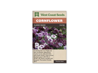 Sachet Classic Magic de West Coast Seeds sur fond blanc. La photo montre un groupe de fleurs pourpre foncé, mauves et presque blanches. Plusieurs ont des pointes claires ou un centre violet, sur des tiges vertes visibles entre les fleurs. Le bandeau orangé indique Cornflower; Classic Magic et FL2184 se lisent dans la bande brune.