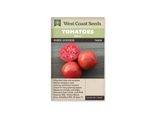 Sachet West Coast Seeds portant les mentions Tomatoes, Slicer et Rubee Goddess. La photo montre deux tomates rouges entières et une moitié coupée, posées sur une surface de bois sombre. La coupe laisse voir la chair et les loges du fruit. Le nom figure sur une bande foncée sous le bandeau vert de la marque.