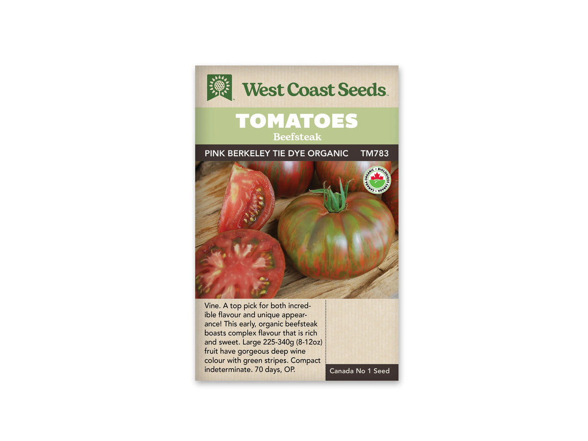 Sachet West Coast Seeds portant les mentions Tomatoes, Beefsteak et Pink Berkeley Tie Dye Organic. La photo montre des tomates rayées de vert et de rouge, entières et coupées, avec une chair rose rouge sur du bois. Un logo biologique rond apparaît à droite. Le code TM783 figure sous le nom de la variété.