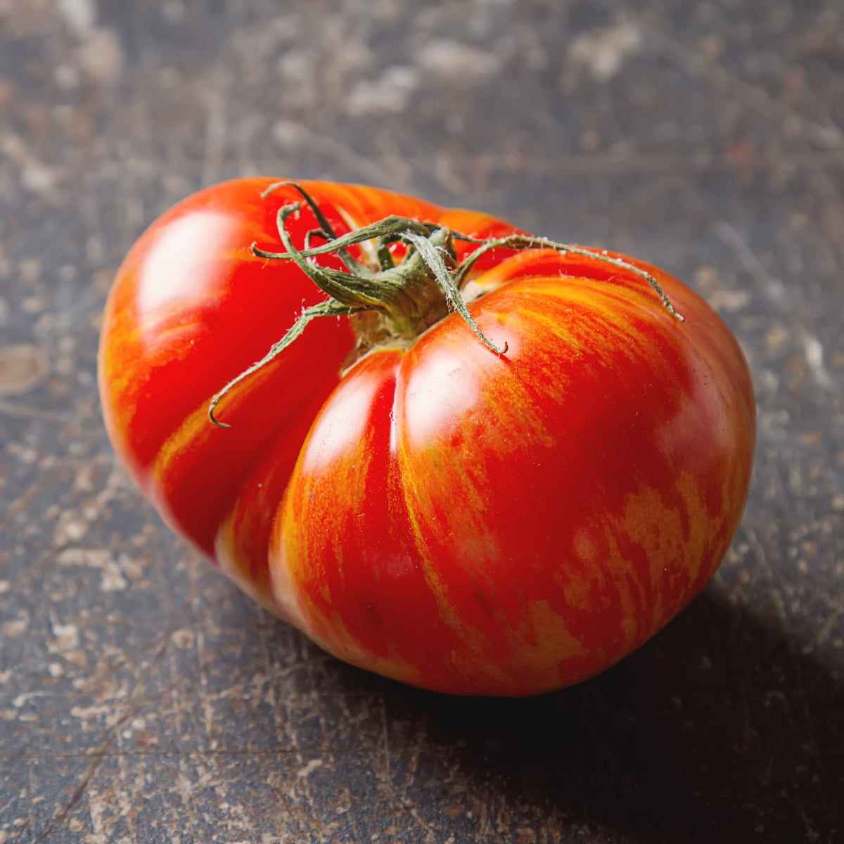 Photo de Tomate 'Striped German'. La couleur caractéristique est : jaune. Le visuel permet d'observer les contours, les teintes et la disposition des éléments présentés. Les détails de forme et les contrastes donnent un aperçu de l'apparence de cette plante ou de sa récolte. Cette photographie accompagne la variété nommée afin de l'identifier dans la sélection de semences.