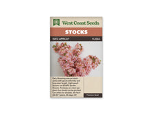 Le sachet de West Coast Seeds présente plusieurs tiges de giroflées aux fleurs doubles rose pêche et abricot clair. Des boutons verts et rosés restent visibles au sommet des épis. Les pétales se superposent sur un fond clair, avec quelques tiges vertes apparentes. Le nom Katz Apricot et la référence FL2066 figurent au-dessus de la photo.
