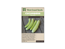 Sachet beige portant le nom Armenian sous une bande verte et une bande brune. La photographie montre quatre longs fruits vert pâle aux côtes très marquées, disposés côte à côte sur des planches de bois gris. Plusieurs fruits sont légèrement courbés et gardent leur pédoncule. Un texte descriptif anglais apparaît sous la photographie centrale.